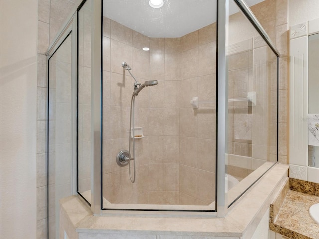 bathroom with an enclosed shower and vanity