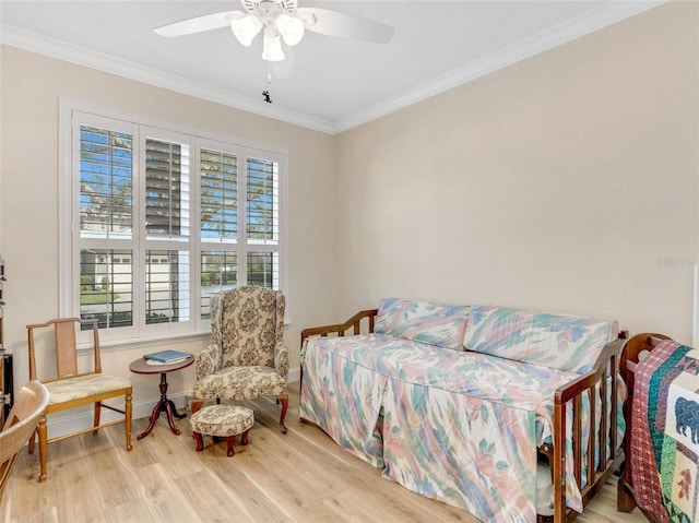 bedroom featuring crown molding, ceiling fan, and light hardwood / wood-style flooring