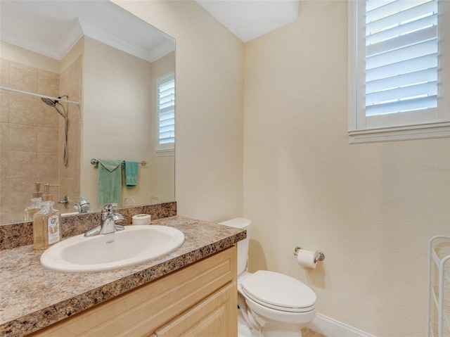 bathroom featuring crown molding, vanity, toilet, and plenty of natural light