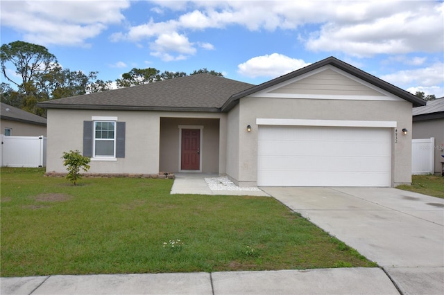 ranch-style house featuring a garage and a front yard