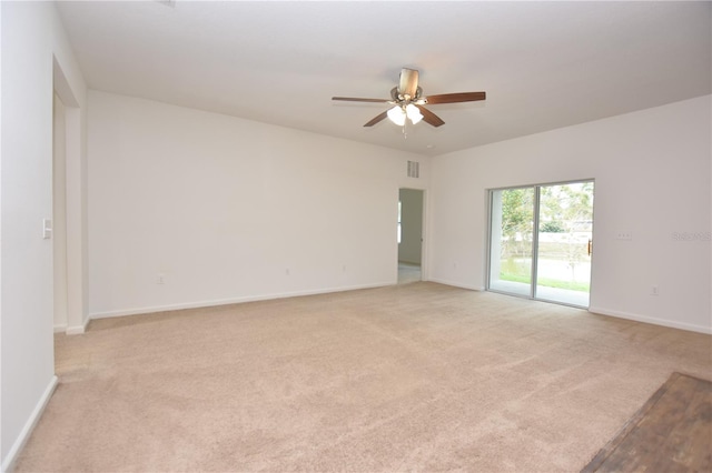 carpeted spare room with ceiling fan