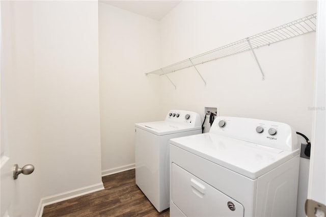 clothes washing area with washer and dryer and dark hardwood / wood-style floors