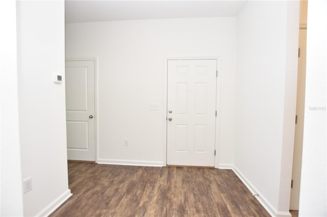 unfurnished room featuring dark hardwood / wood-style flooring