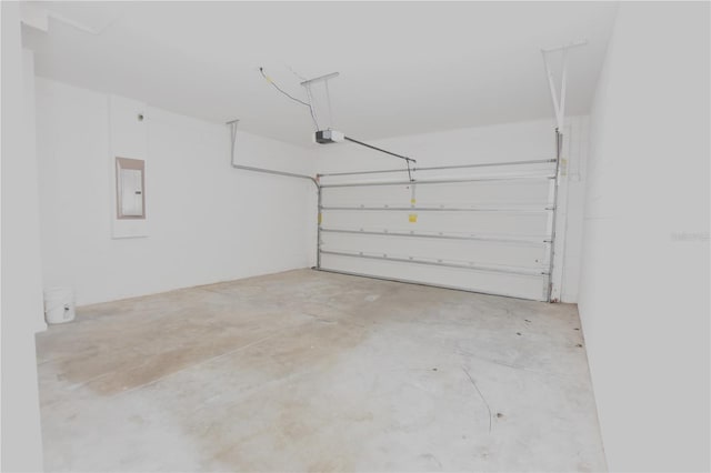 garage with a garage door opener and electric panel