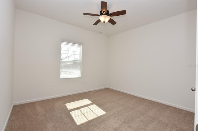 unfurnished room featuring light colored carpet and ceiling fan