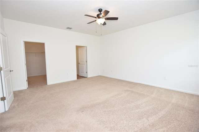 unfurnished room featuring light colored carpet and ceiling fan