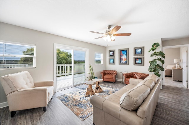 living room with ceiling fan and dark hardwood / wood-style floors