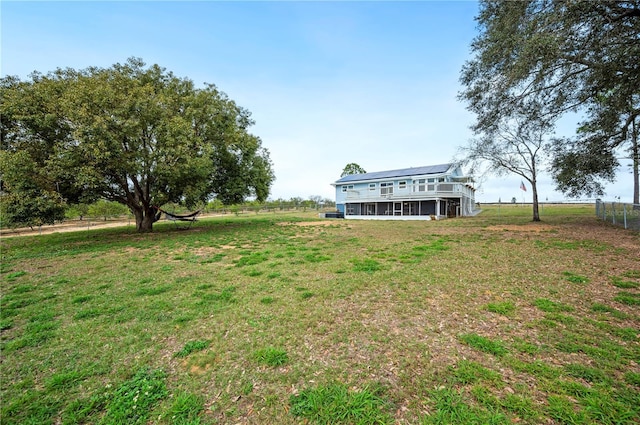 view of yard with a rural view and a wooden deck