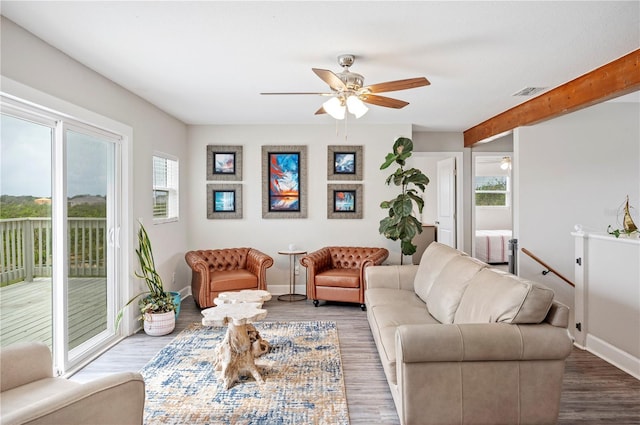 living room with beamed ceiling, ceiling fan, and wood-type flooring