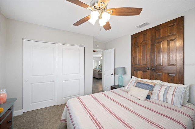 bedroom featuring ceiling fan, a closet, and dark colored carpet