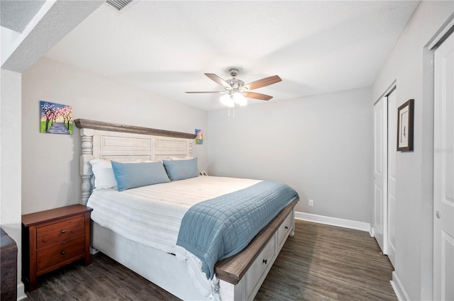 bedroom with dark wood-type flooring, a closet, and ceiling fan