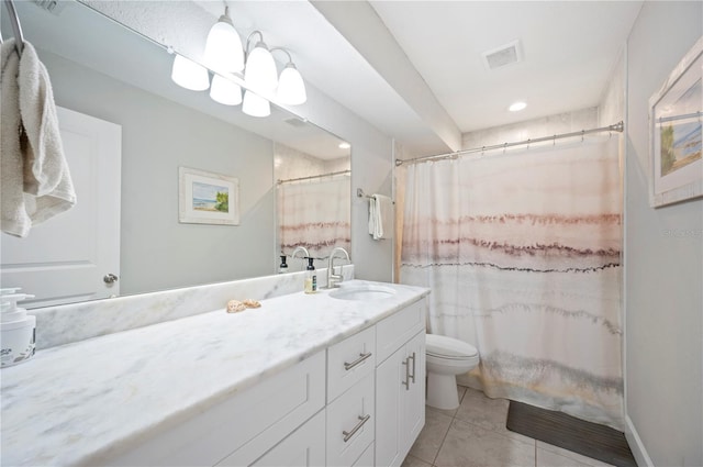 bathroom with tile patterned flooring, vanity, walk in shower, and toilet