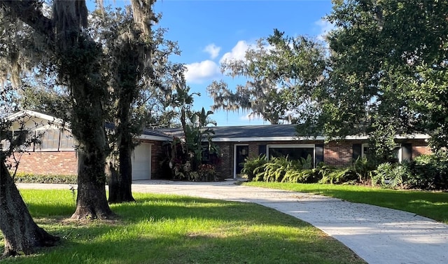 single story home with a garage and a front yard