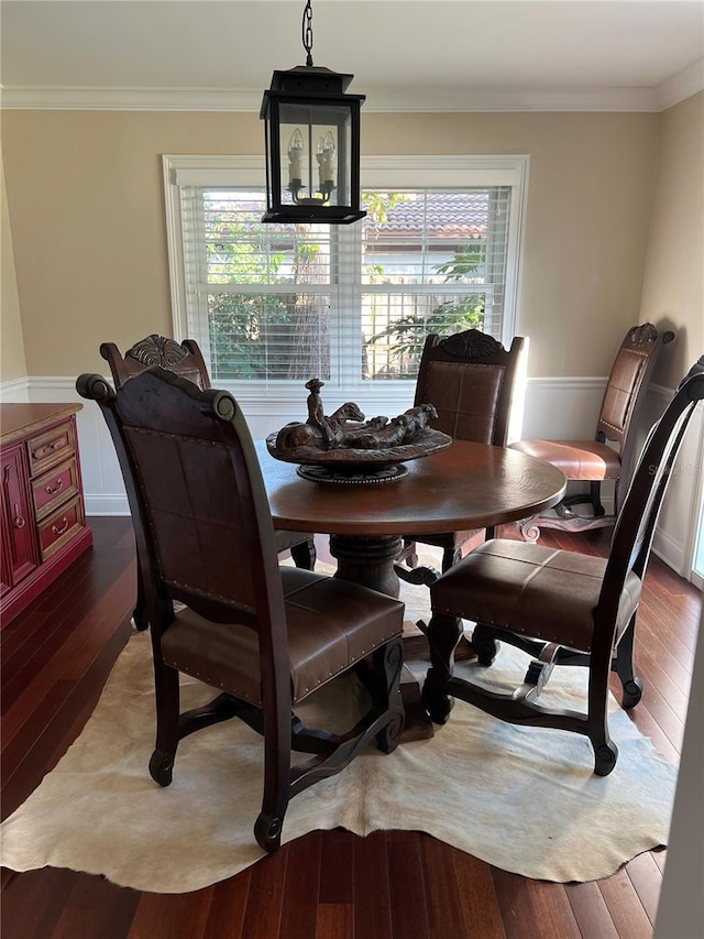 dining space with crown molding and wood-type flooring