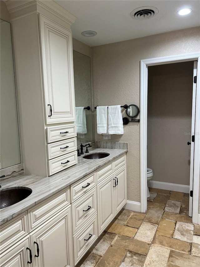 bathroom with vanity and toilet