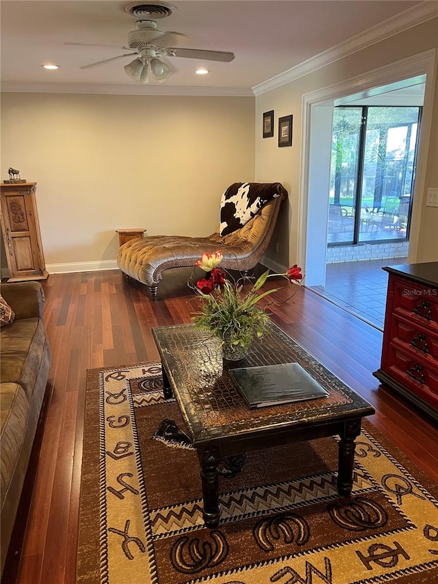 living room featuring crown molding, dark hardwood / wood-style floors, and ceiling fan