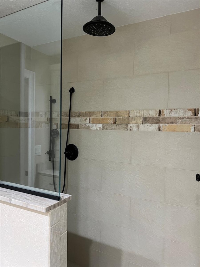 bathroom with a tile shower