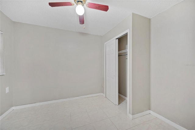 unfurnished bedroom with ceiling fan, a closet, and a textured ceiling