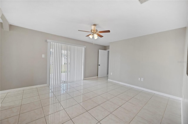 empty room with light tile patterned flooring and ceiling fan