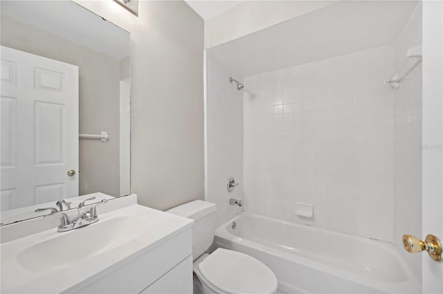 full bathroom with vanity, tiled shower / bath, and toilet