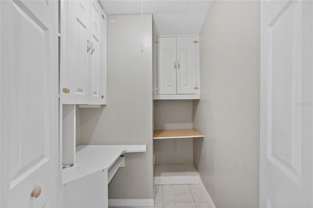 interior space featuring built in desk and light tile patterned floors