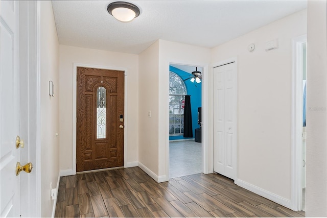 entrance foyer featuring dark wood-type flooring and a textured ceiling