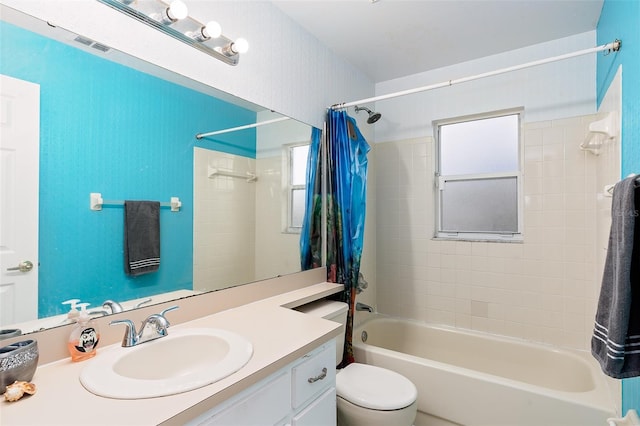 full bathroom featuring vanity, shower / tub combo with curtain, and toilet