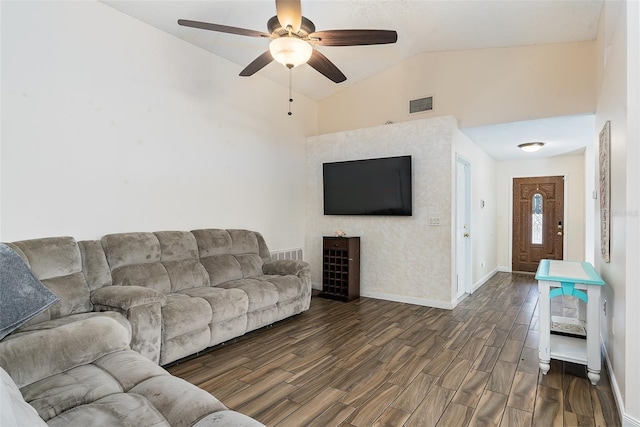 living room with dark hardwood / wood-style flooring, vaulted ceiling, and ceiling fan