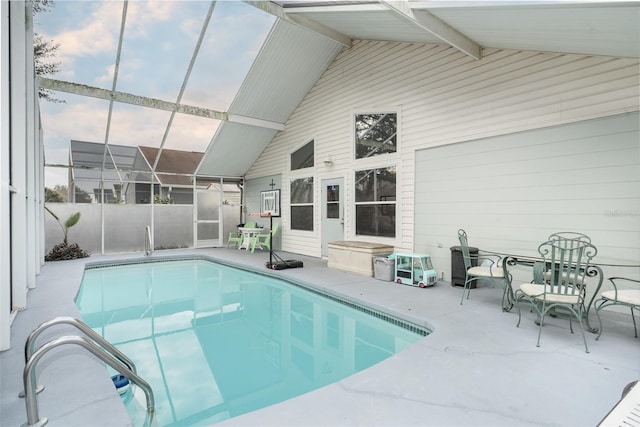 view of swimming pool featuring a lanai and a patio area