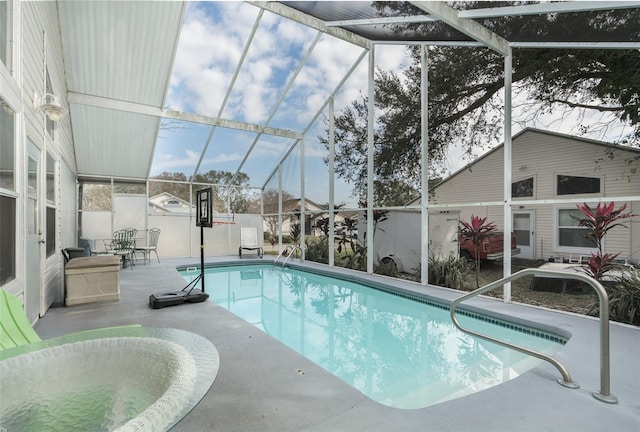 view of swimming pool featuring a patio and glass enclosure