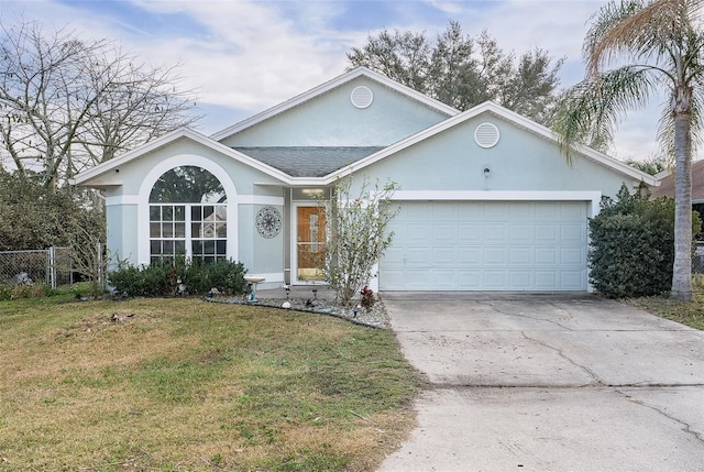 single story home with a garage and a front lawn