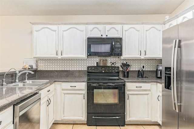 kitchen featuring white cabinetry, sink, tasteful backsplash, and black appliances