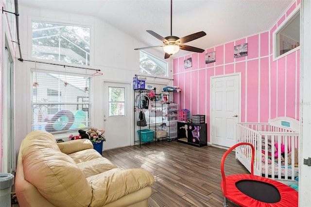 living room featuring ceiling fan, lofted ceiling, and dark hardwood / wood-style flooring