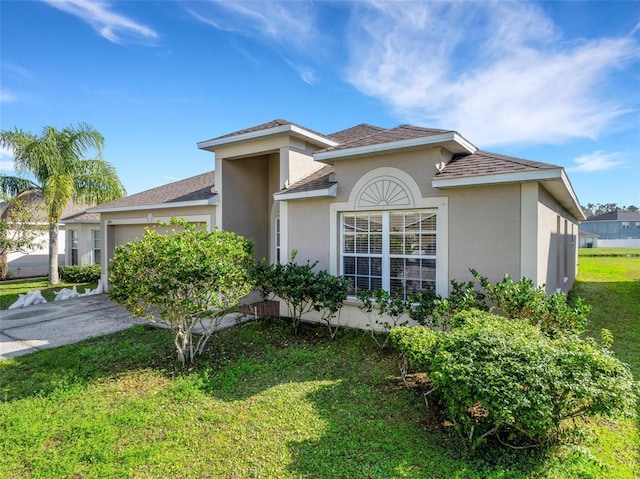 view of front of home with a garage and a front yard