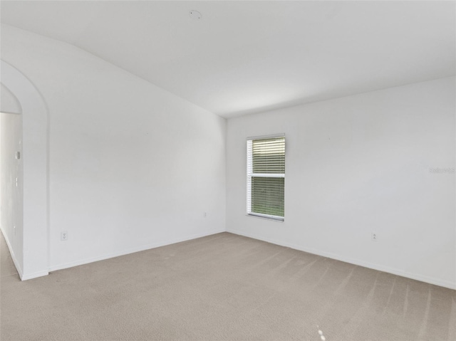 unfurnished room with light colored carpet