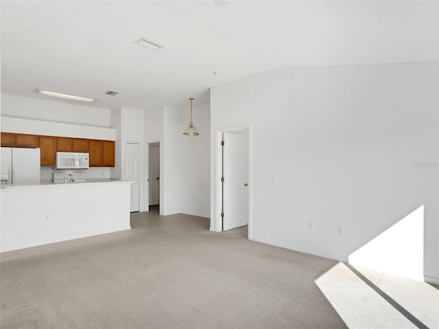 unfurnished living room with lofted ceiling and light colored carpet