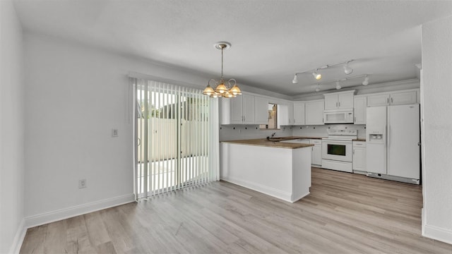 kitchen with white cabinetry, kitchen peninsula, pendant lighting, white appliances, and light hardwood / wood-style floors