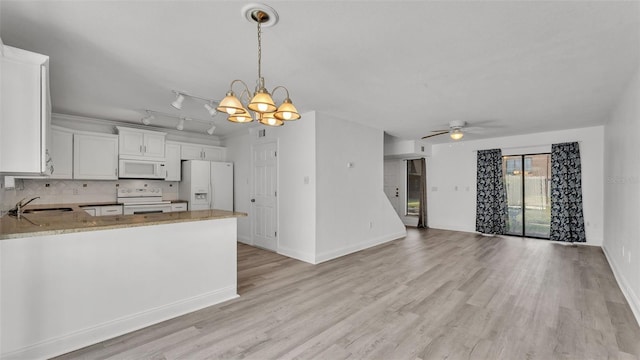 kitchen with pendant lighting, sink, white appliances, white cabinetry, and kitchen peninsula