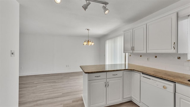 kitchen featuring decorative light fixtures, white cabinets, white dishwasher, kitchen peninsula, and light hardwood / wood-style flooring