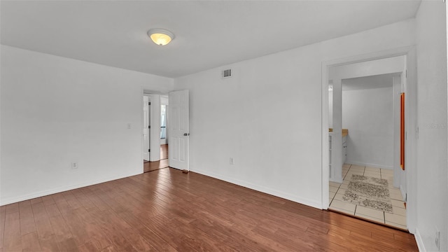 spare room with hardwood / wood-style floors