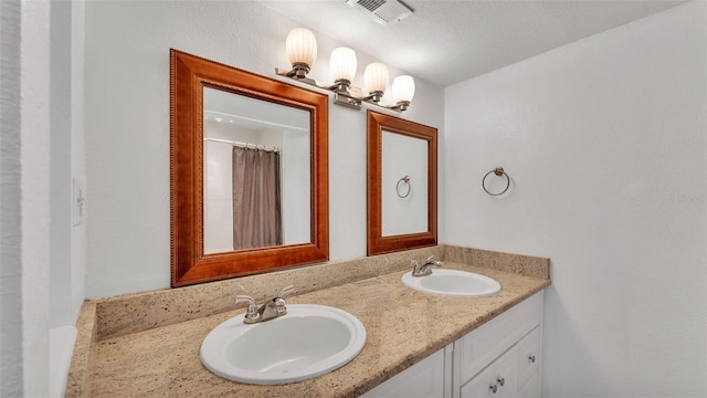 bathroom with vanity and a chandelier