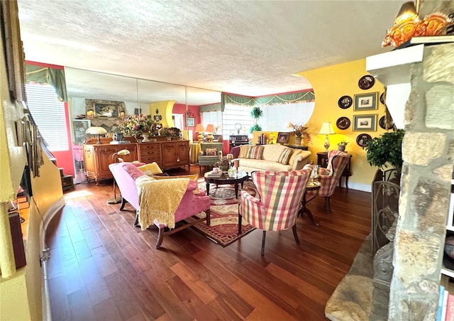 living room with dark wood-type flooring and a textured ceiling