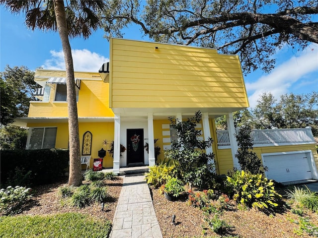 view of front of home with a garage and a porch