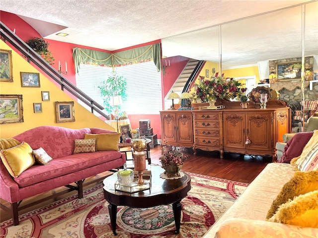 living room featuring dark hardwood / wood-style flooring and a textured ceiling