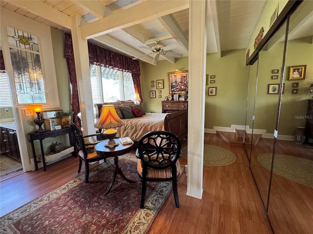 bedroom with beamed ceiling and wood-type flooring