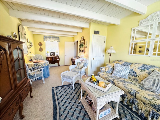 carpeted living room featuring beam ceiling