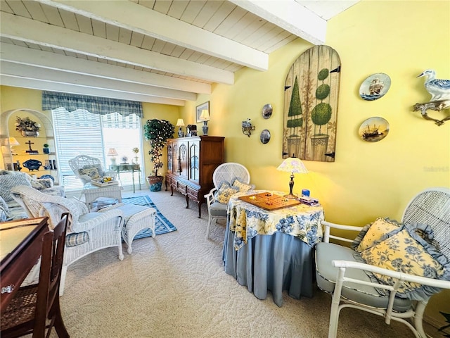 dining space with beamed ceiling, wood ceiling, and carpet