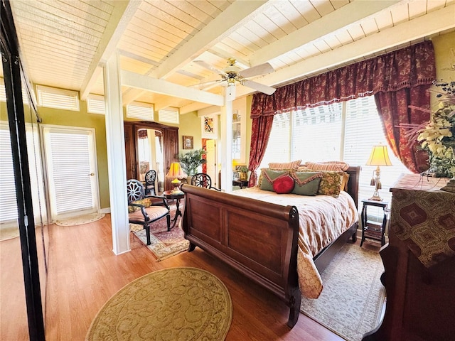 bedroom featuring wood ceiling, wood finished floors, beam ceiling, and a ceiling fan