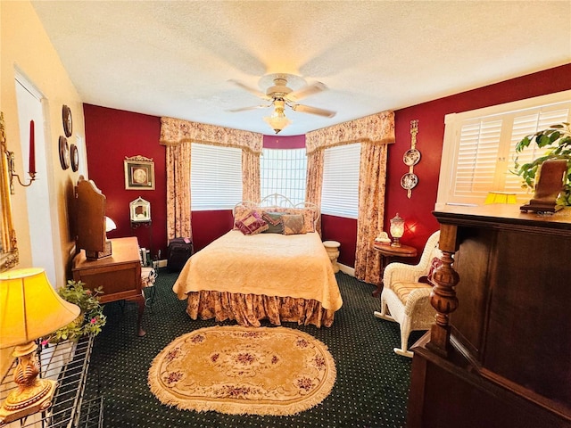 bedroom with a ceiling fan, carpet flooring, a textured ceiling, and baseboards