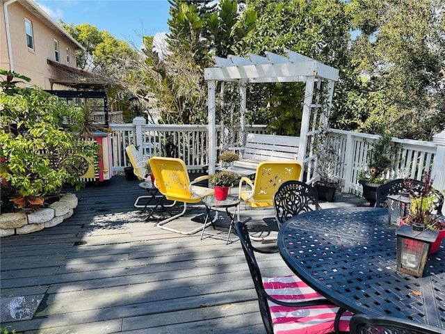 deck with outdoor dining space and a pergola